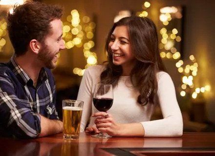 A couple dating with a glass of wine and beer